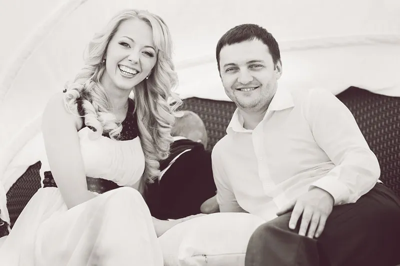 Black and white portrait of a smiling couple on a sofa
